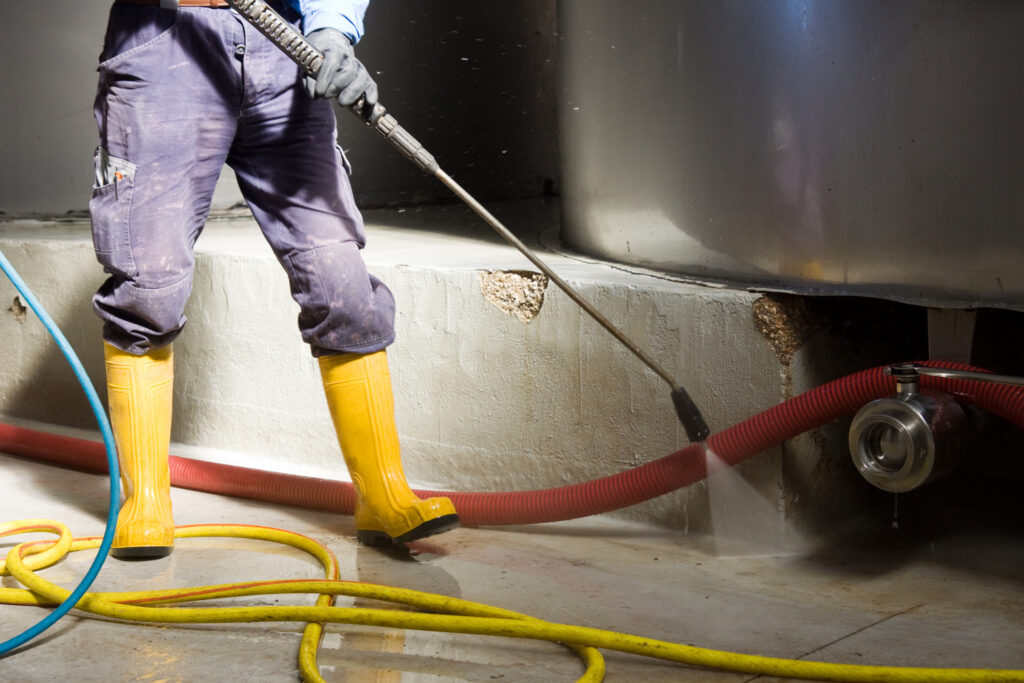 man cleaning an industrial site after a disaster